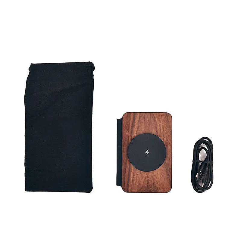 Three-in-one foldable magnetic wireless charger with walnut base and stand, charging a phone, earbuds and watch.