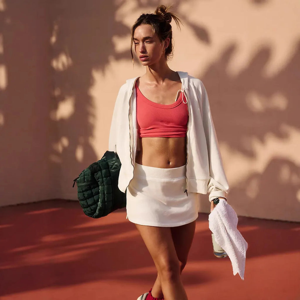 Women's solid colour hooded jacket and mini skirt street-style co-ord set.