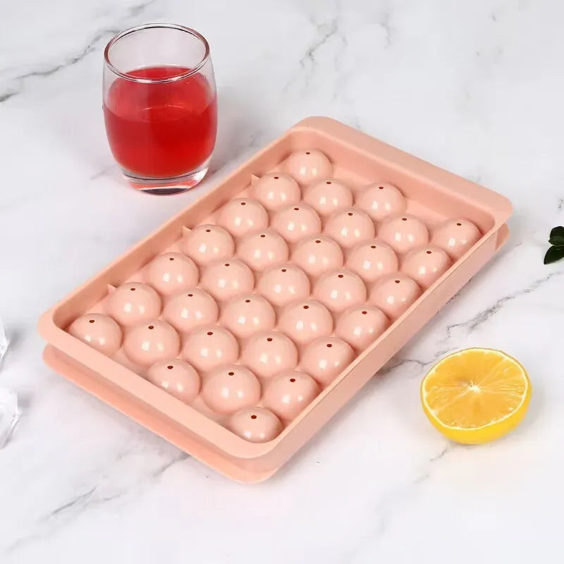 Blue round silicone ice cube tray with lid showing 33 mould cavities