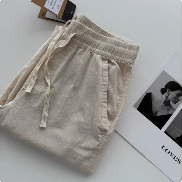 Men's loose straight casual pants in beige colour with drawstring waist detail for summer wear