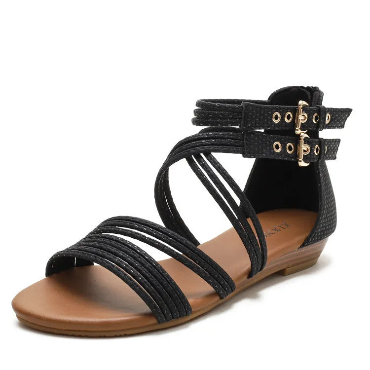 Women's black open toe Roman sandals with cross straps, a buckle, and a back zipper.