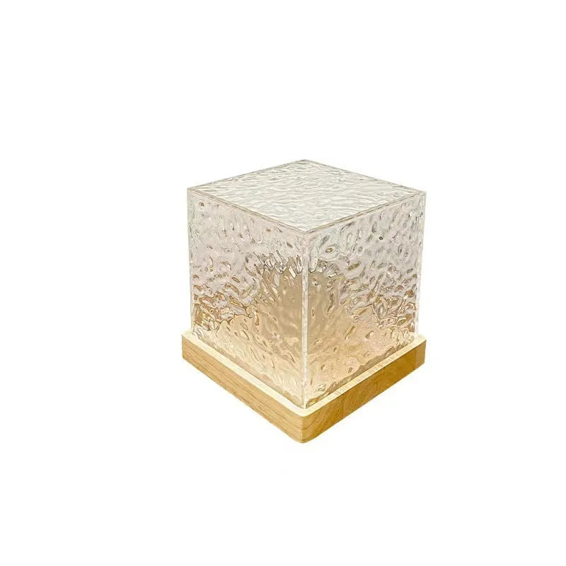 Geometric crystal LED table lamp projecting blue water ripple light patterns on wall with remote control
