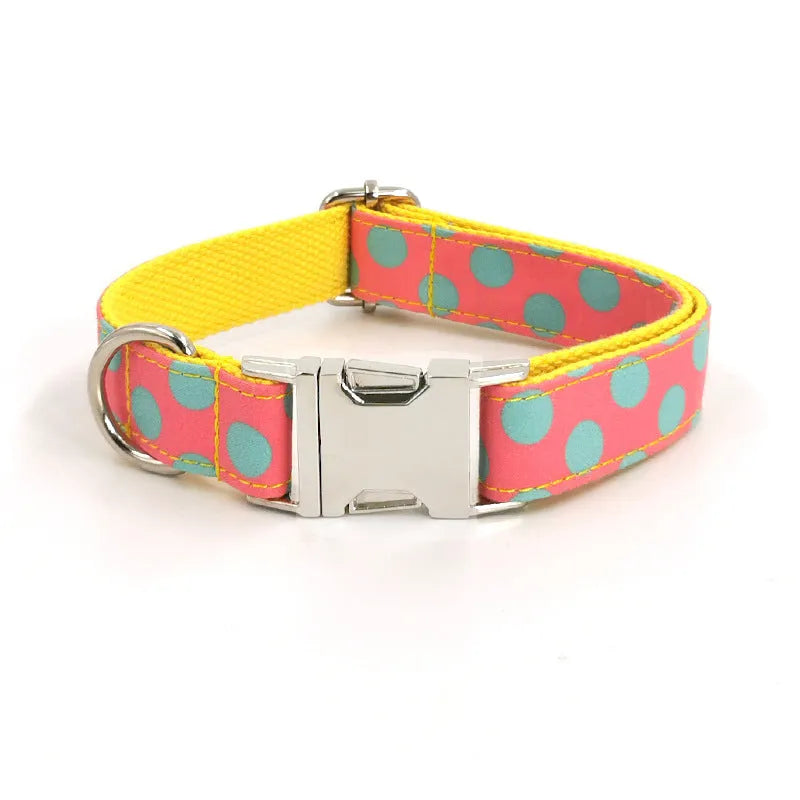 Yellow polka dot dog collar with bow and matching lead rope set on a white background.