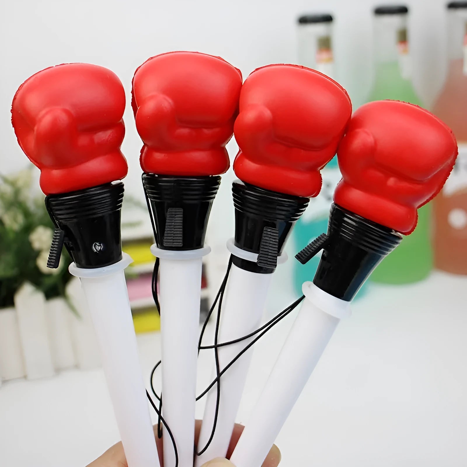 Four black pressure relief boxing press ejection pens with plug-in sleeve mechanisms on a desk.