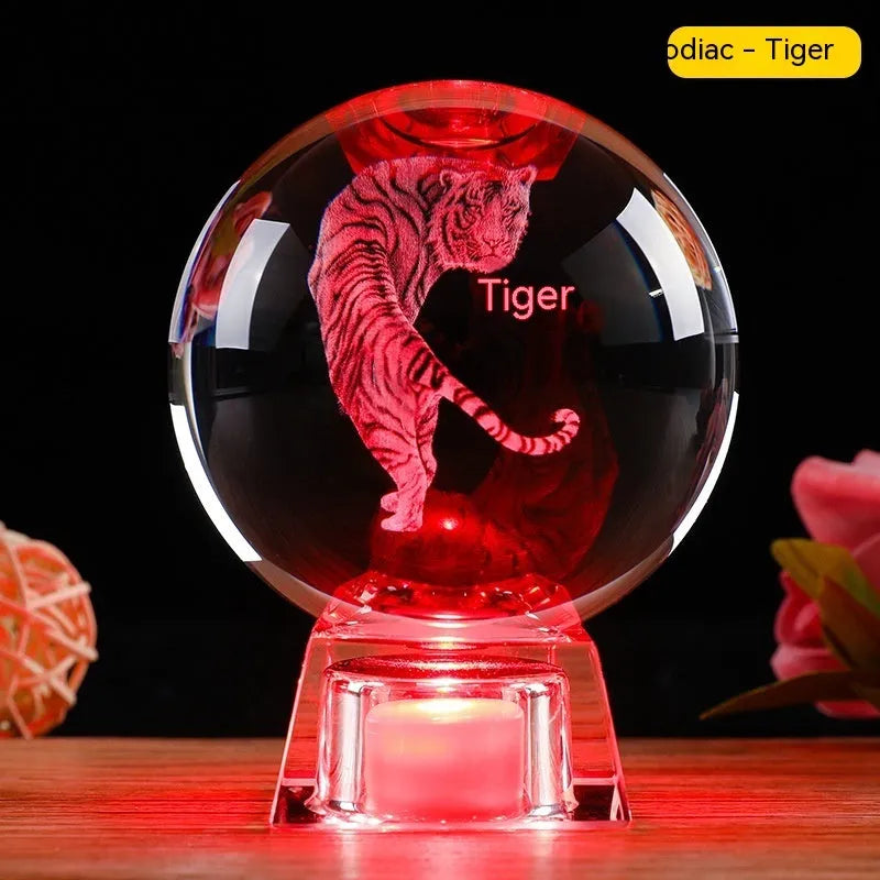 White crystal ball zodiac ornament with luminous electronic base showing Chinese animal designs