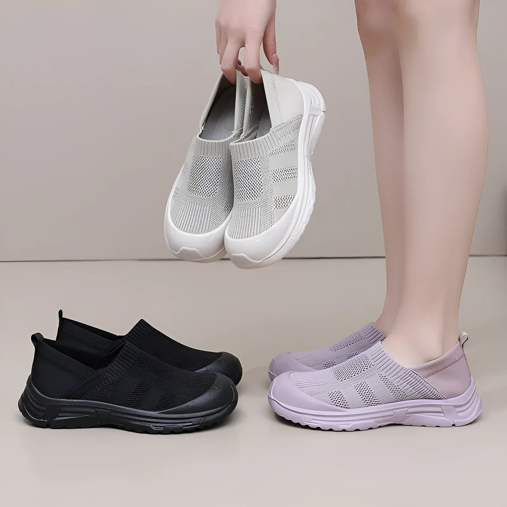 Women's black slip-on shoes with cloth upper and PVC sole showing one pedal design