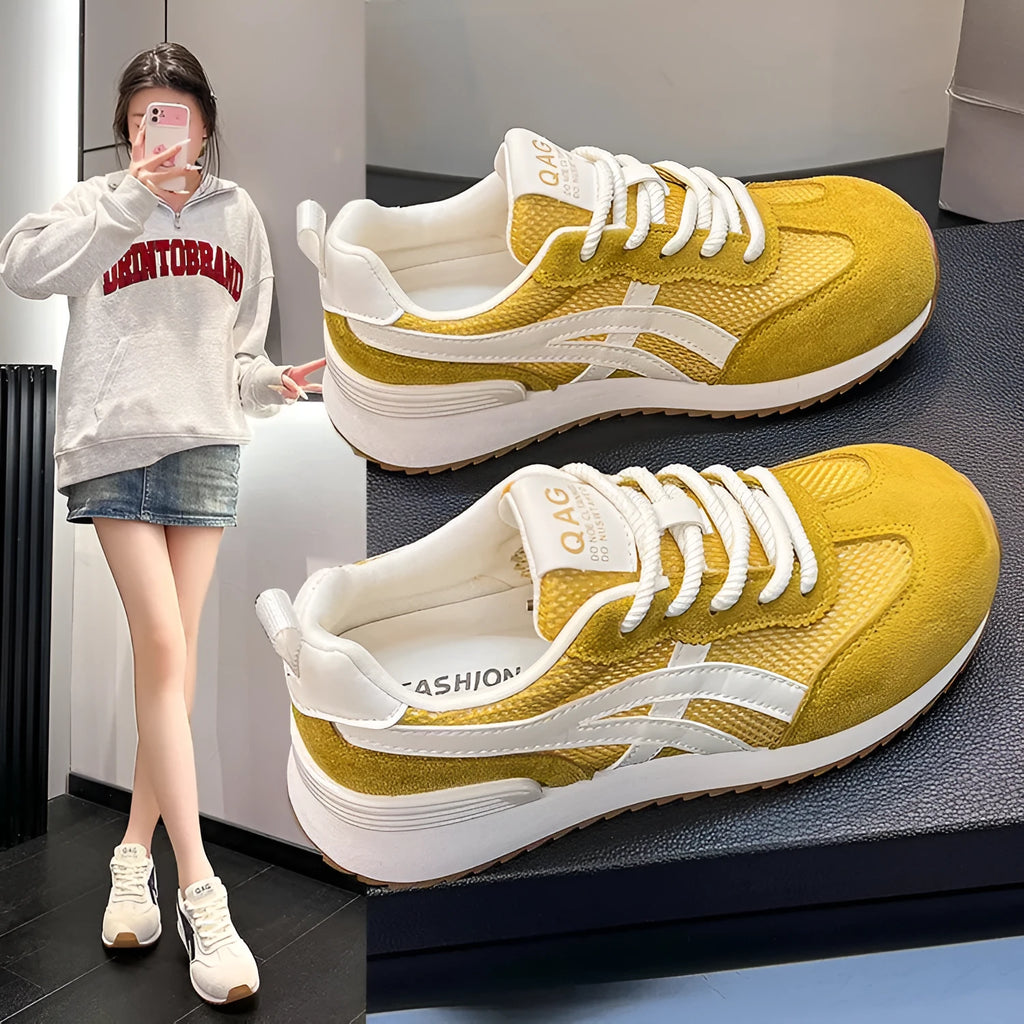 Women's white casual lace-up sneakers with round toe and non-slip sole on a plain background.