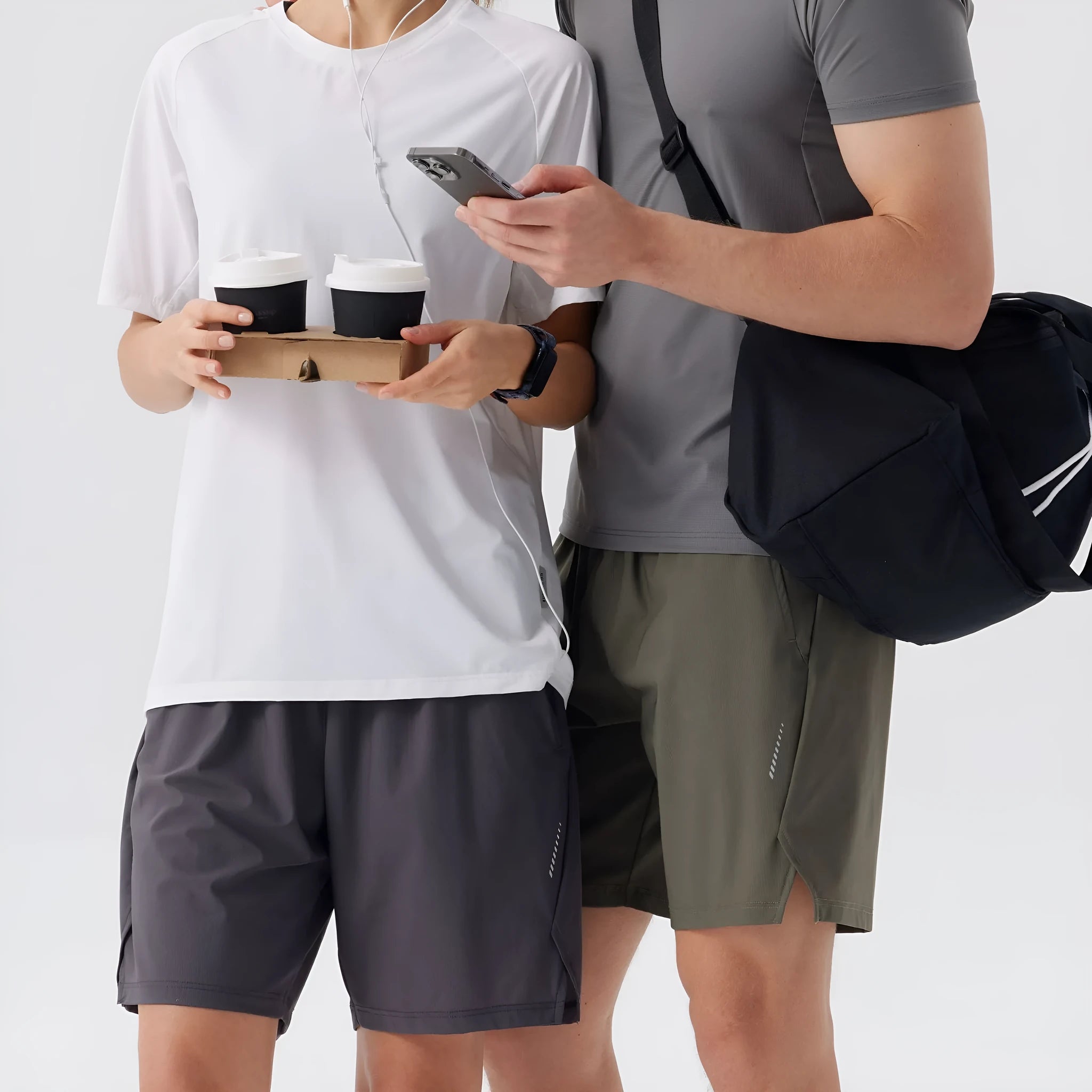 Man wearing grey ice silk nylon sports shorts with a mid-rise waistband.