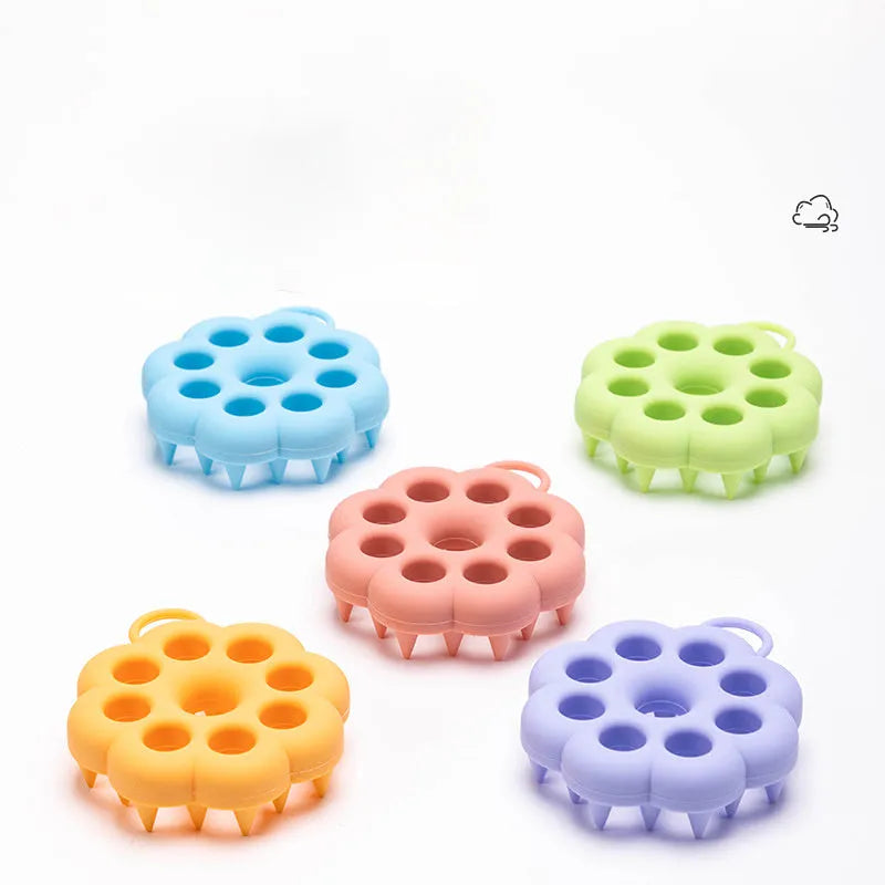 Blue silicone pet grooming brush with soft bristles and an ergonomic massage handle on a white background.