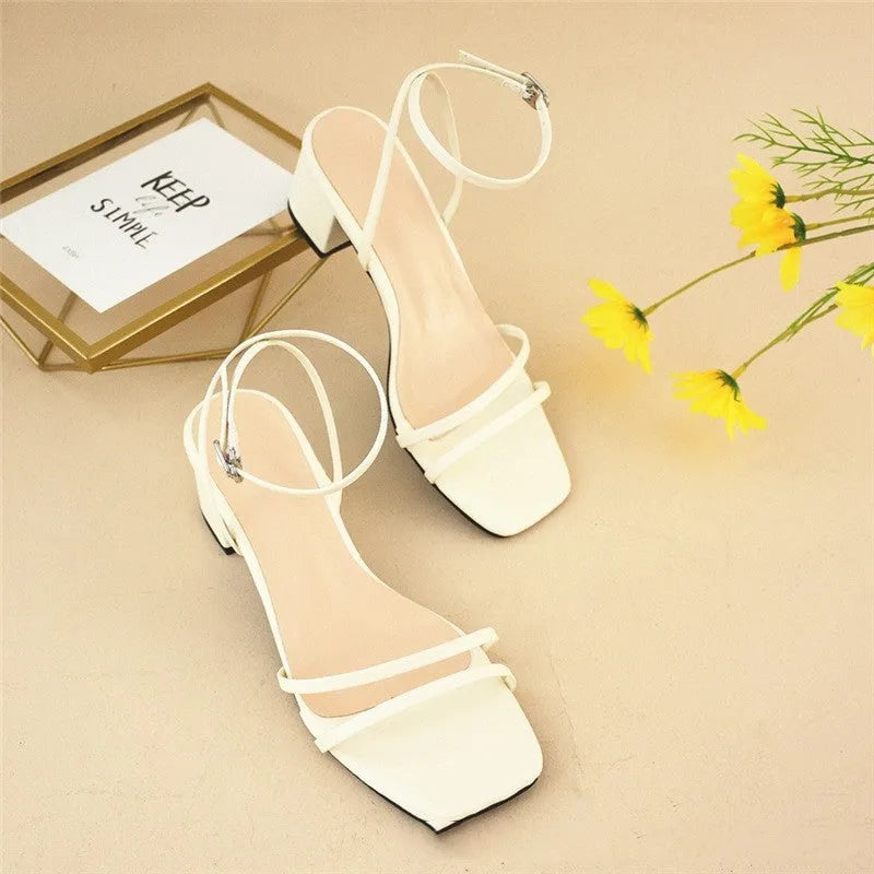 Beige women's chunky heel sandals with a square toe and ankle strap on a rubber sole.