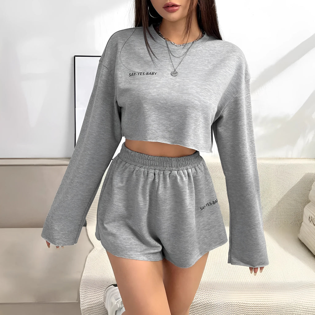Grey women's long sleeve t-shirt and matching shorts loungewear set laid flat.