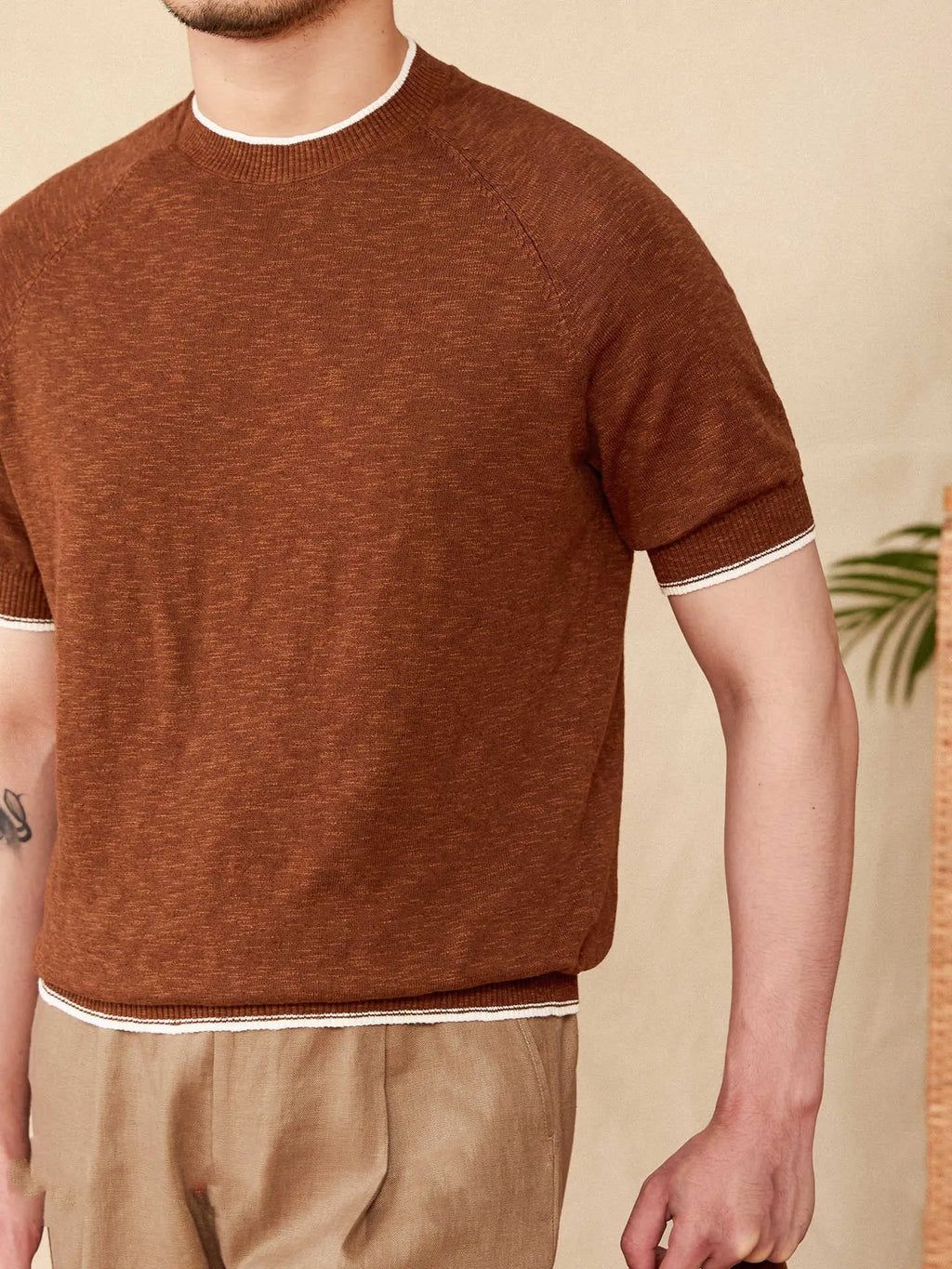Brown linen cotton casual t-shirt with round neck and short sleeves on hanger
