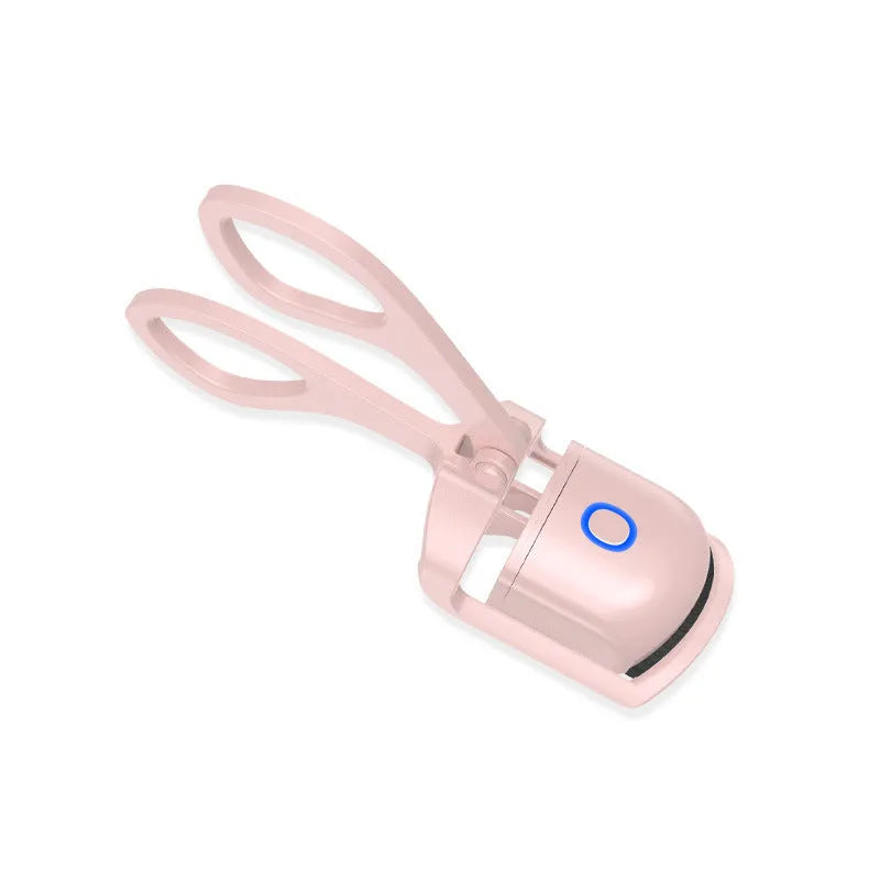 White and pink USB rechargeable heated eyelash curler with dual temperature settings.