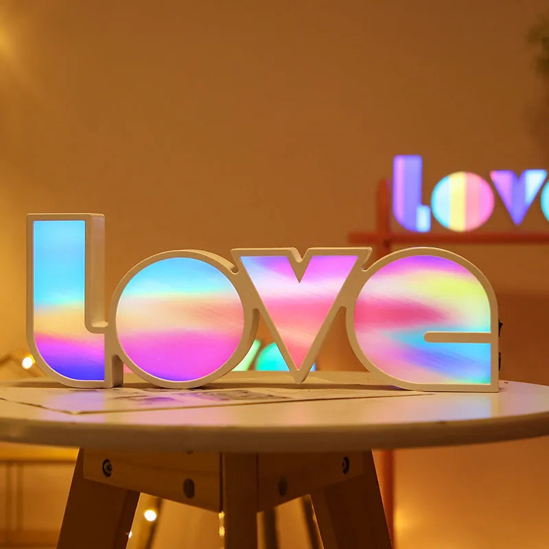 Rainbow style LED LOVE decorative table lamp with plastic shade on a table