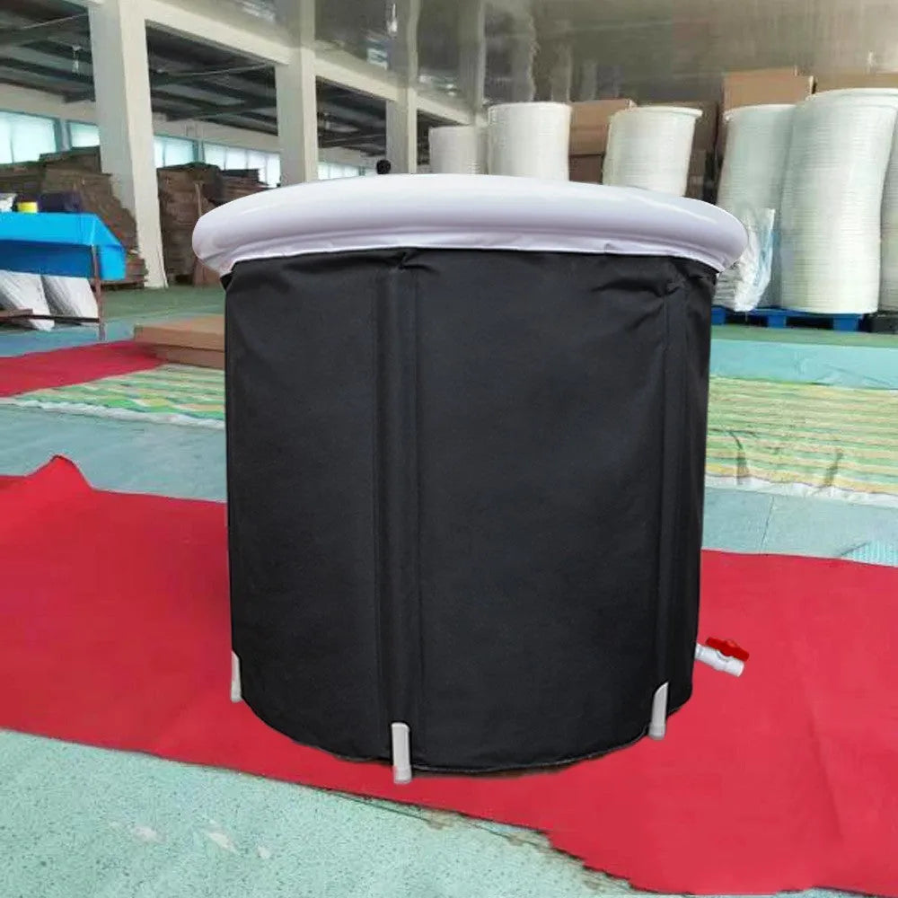 Black inflatable portable ice bath tub with weather lid, shown outdoors.