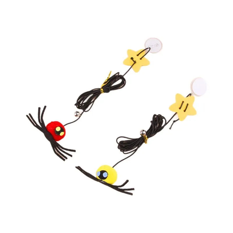 Red and yellow feather cat toy hanging from door on elastic rope with bell spider element for indoor feline play