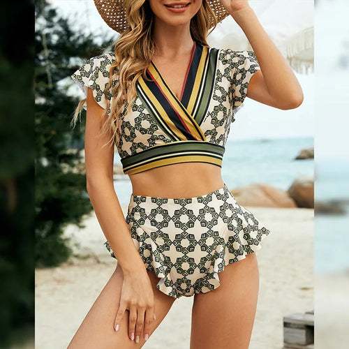 Green flounced backless bikini swimsuit with lace-up V-neck top and split shorts.