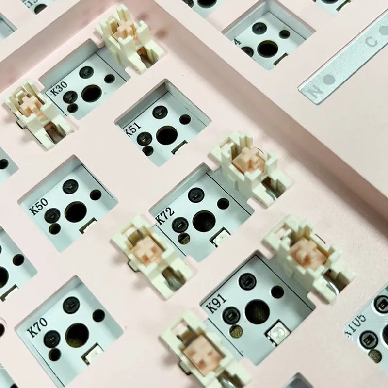 DIY mechanical keyboard kit with transparent case showing internal components and key puller tool