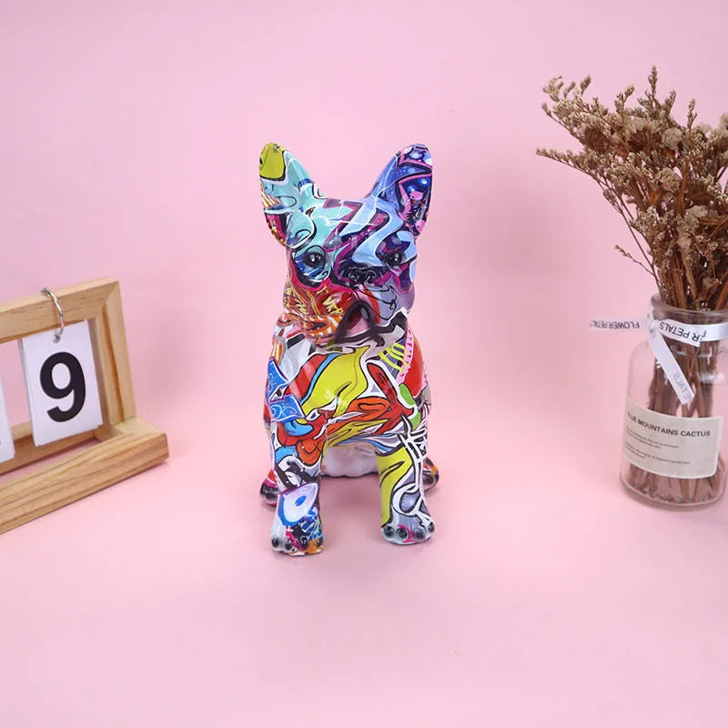 Graffiti-coloured resin French bulldog statue on a plain background.