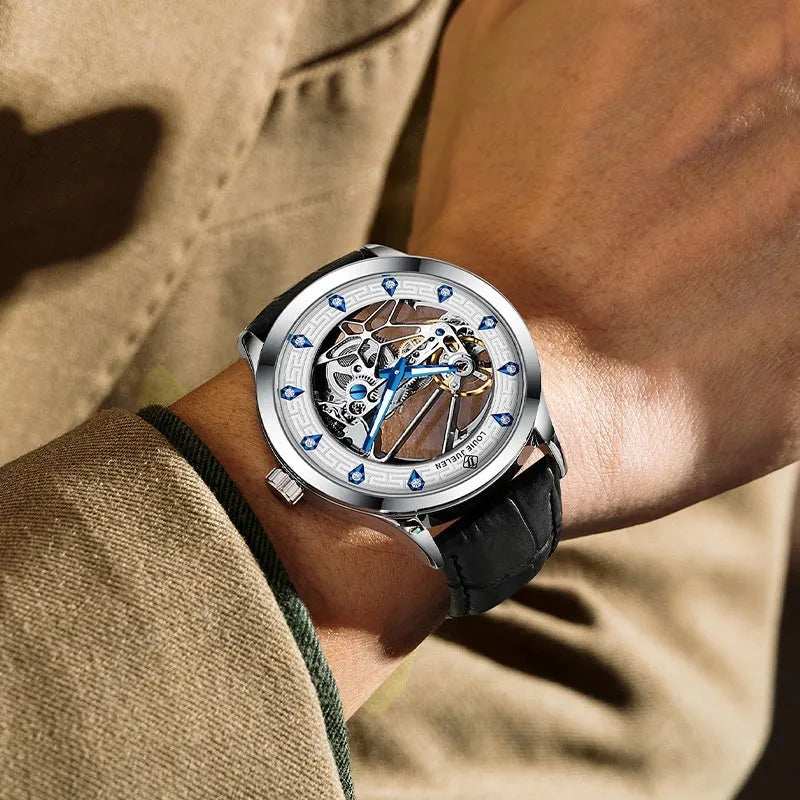 Men's silver case mechanical watch with white dial, blue hands, and a black leather strap.