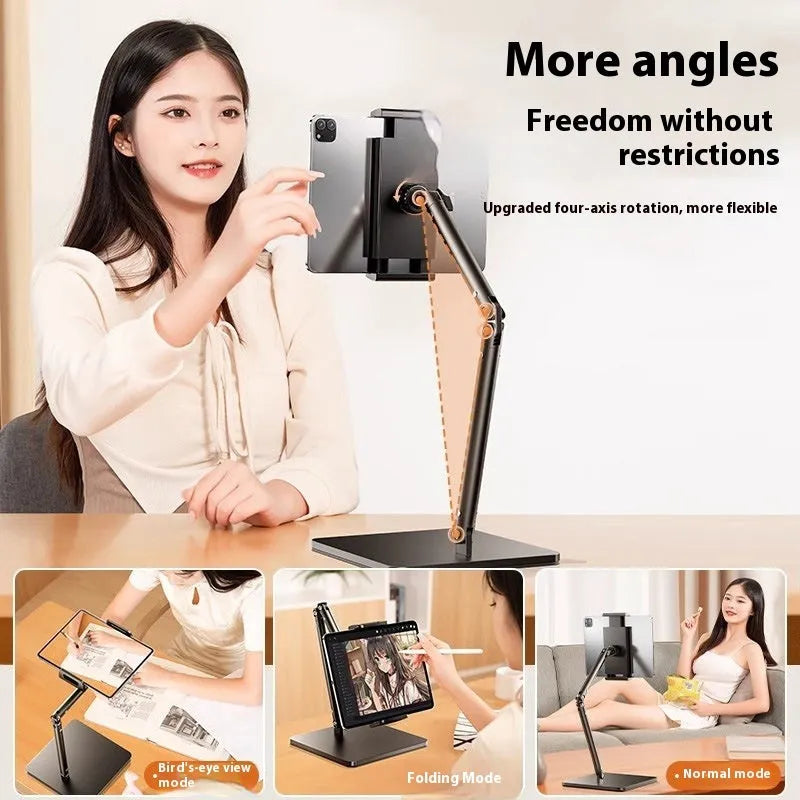 Silver alloy desktop phone and tablet bracket with double adjustable arms and a remote control on a wooden desk.