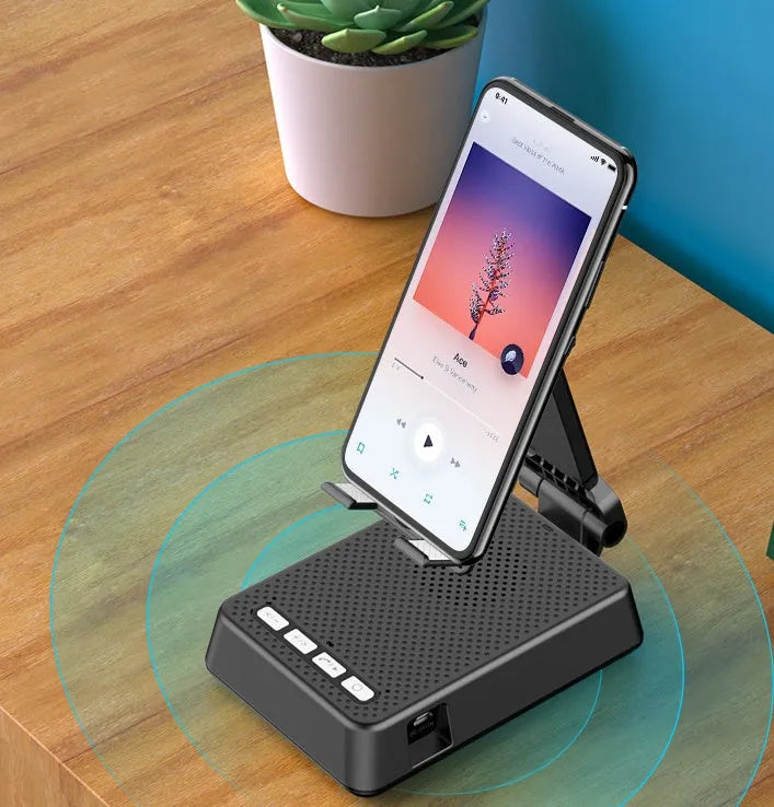 Black mobile phone smart broadcaster stand with Bluetooth speaker and HD mic on a desk