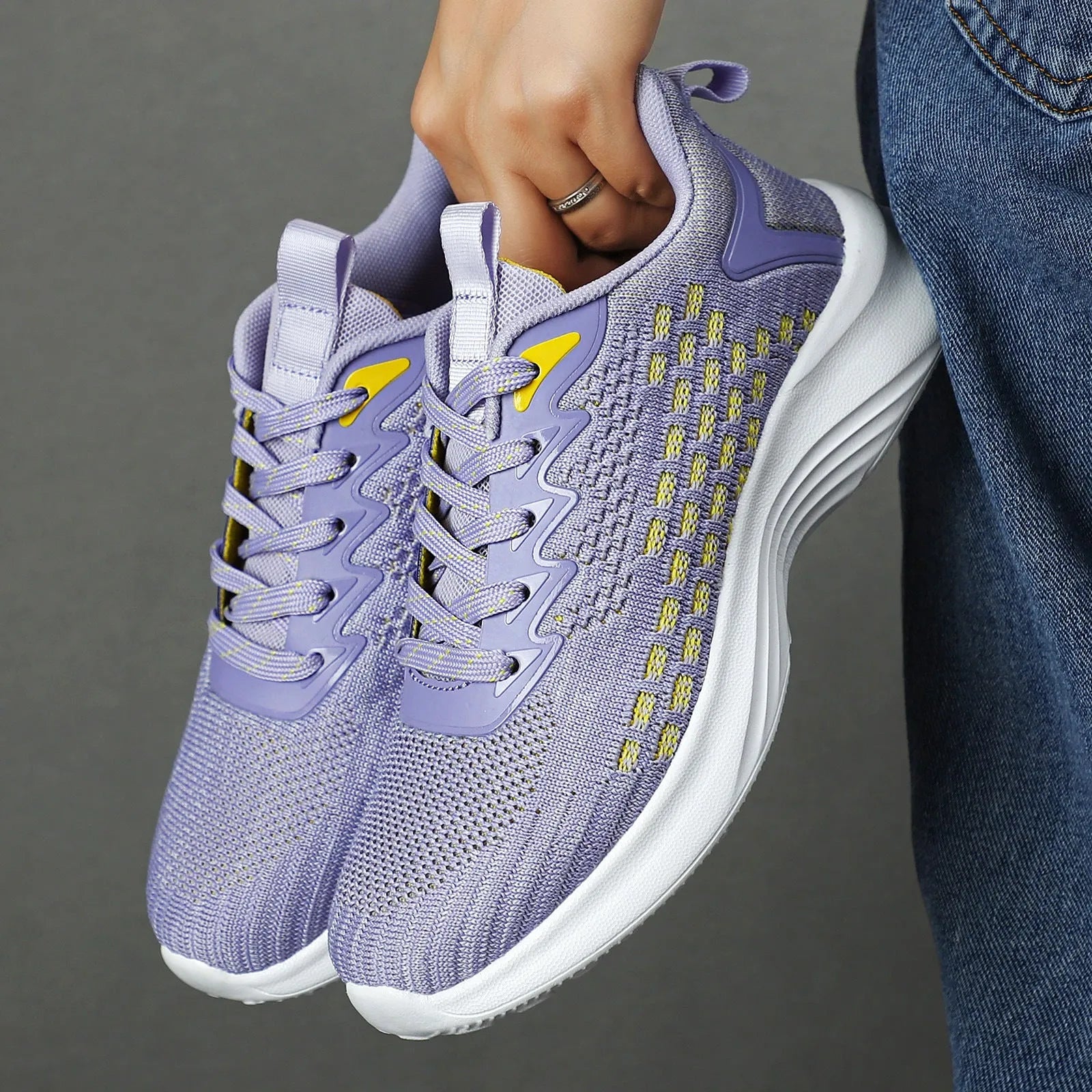 Women's lavender purple Flyknit running shoes with mesh lining and striped pattern.