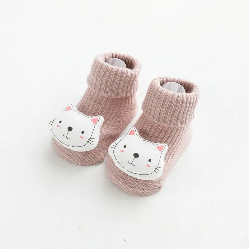 Baby socks with non-slip rubber grip soles on the feet, shown in a light grey colour.