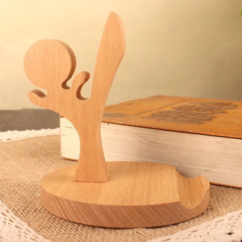 Beech wood and resin lazy bracket mobile phone holder in an animal design style on a desk.
