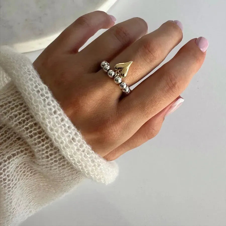 Handmade beaded elastic string love ring with geometric heart design in gold and white colour options