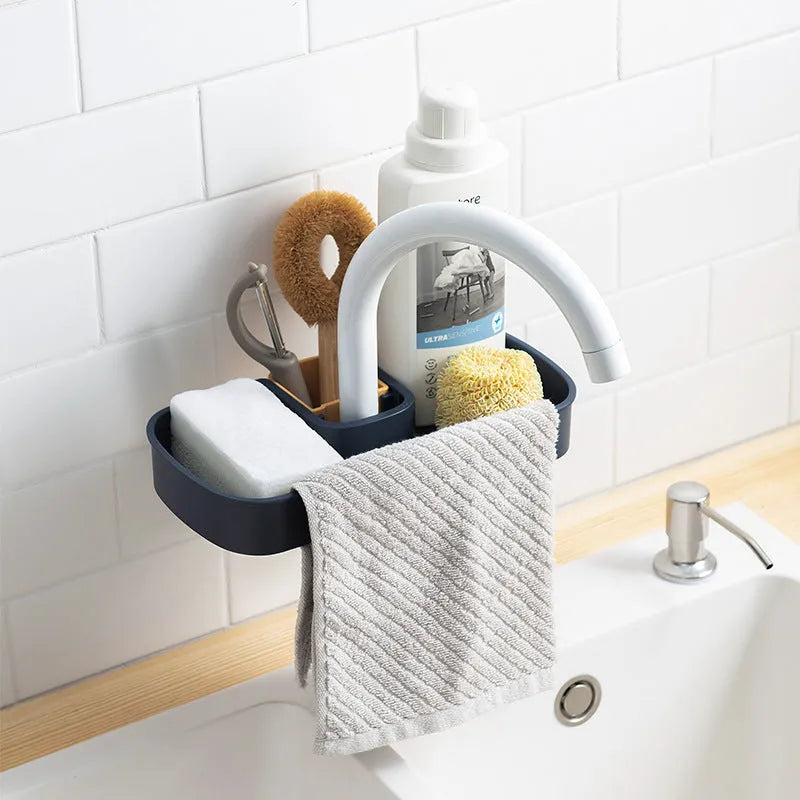 Blue sink shelf faucet holder with sponge and brush storage tray on a kitchen sink