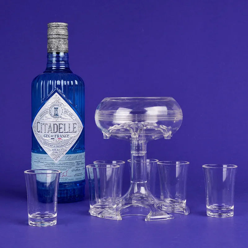 Clear PMMA 6-shot glass dispenser holder with rack and six cups on a table.