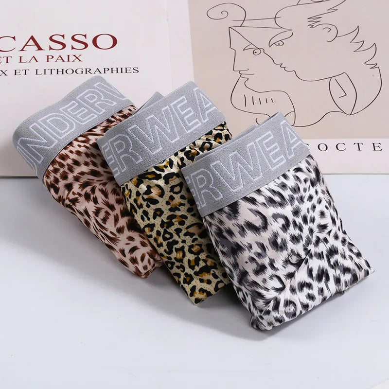 Men's loose fit leopard print underwear in grey and yellow, showing mid-waist design and soft fabric texture.