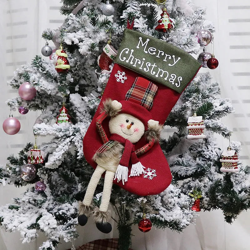 Three large Christmas stockings with Santa, Snowman and Reindeer 3D designs hanging for holiday decoration