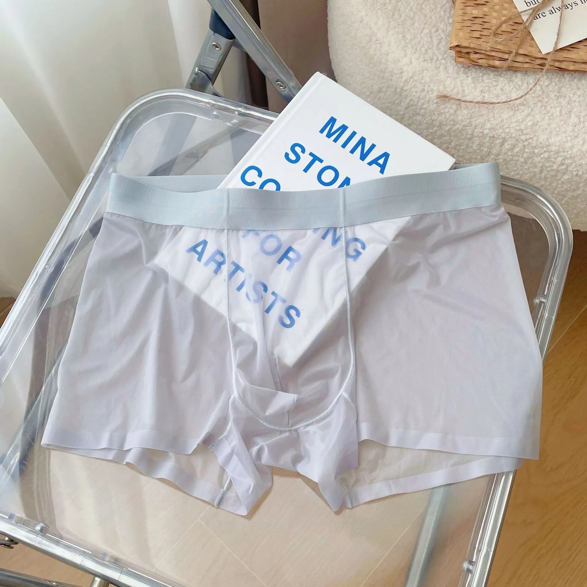 Men's thin grey seamless nylon boxer shorts laid flat, showing mid-waist and body-shaping design.