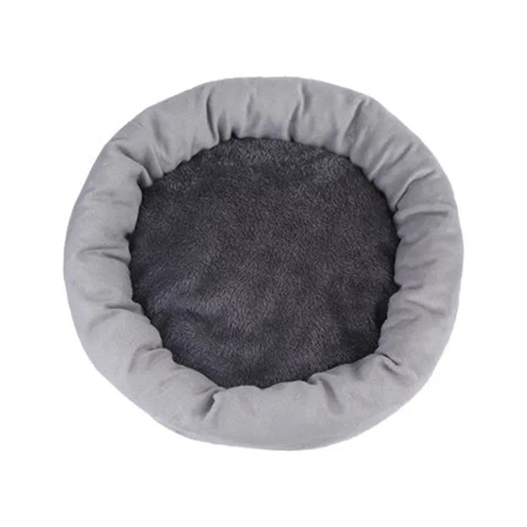 Light grey cotton-filled dog bed showing rounded shape and soft padding, with optional pillow beside it