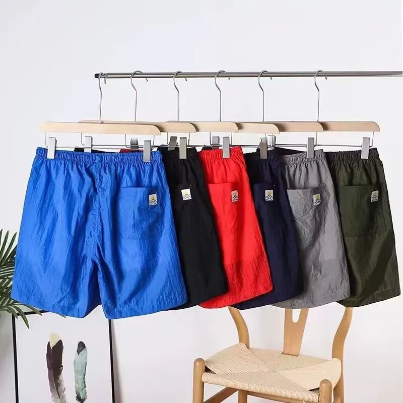 Men's straight cut polyester sports shorts in army green, black, blue, or gray colours