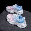 Women's blue satin casual sport shoes with round toe and white laces on a flat lay.