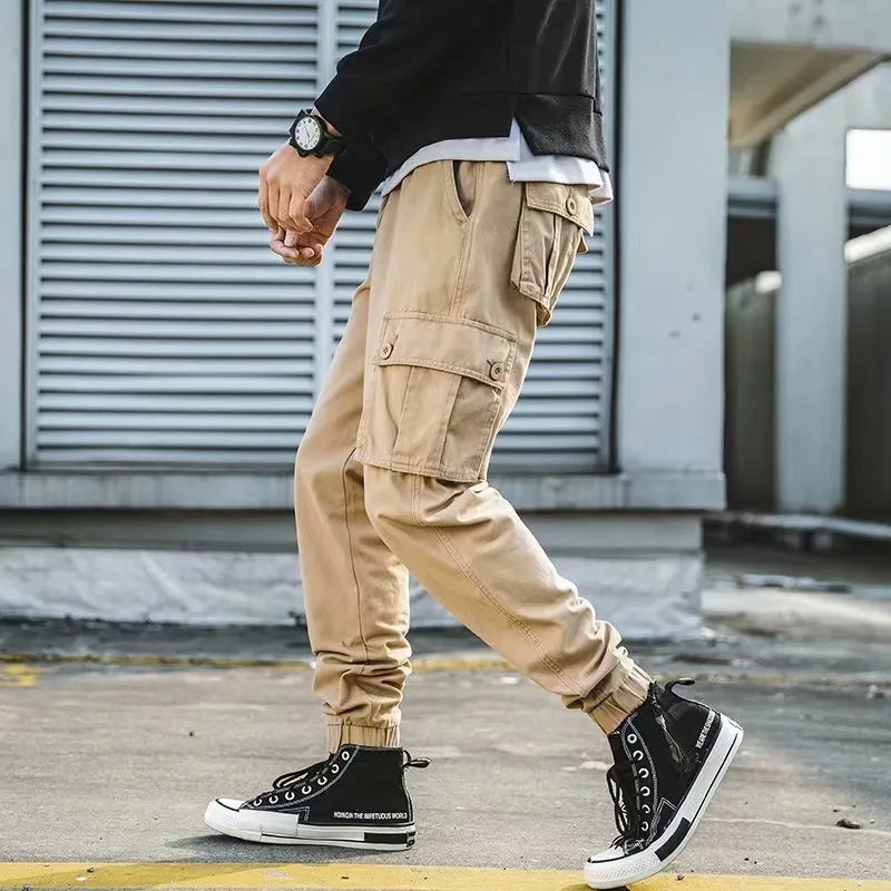 Men's black cotton overalls with loose cropped fit, ankle banded hem, and multiple pockets