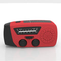 Red rechargeable hand-held emergency radio with integrated torch and wrist strap.