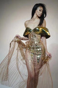 Gold metallic strapless dress with sequin details and a full tulle skirt featuring a high split.