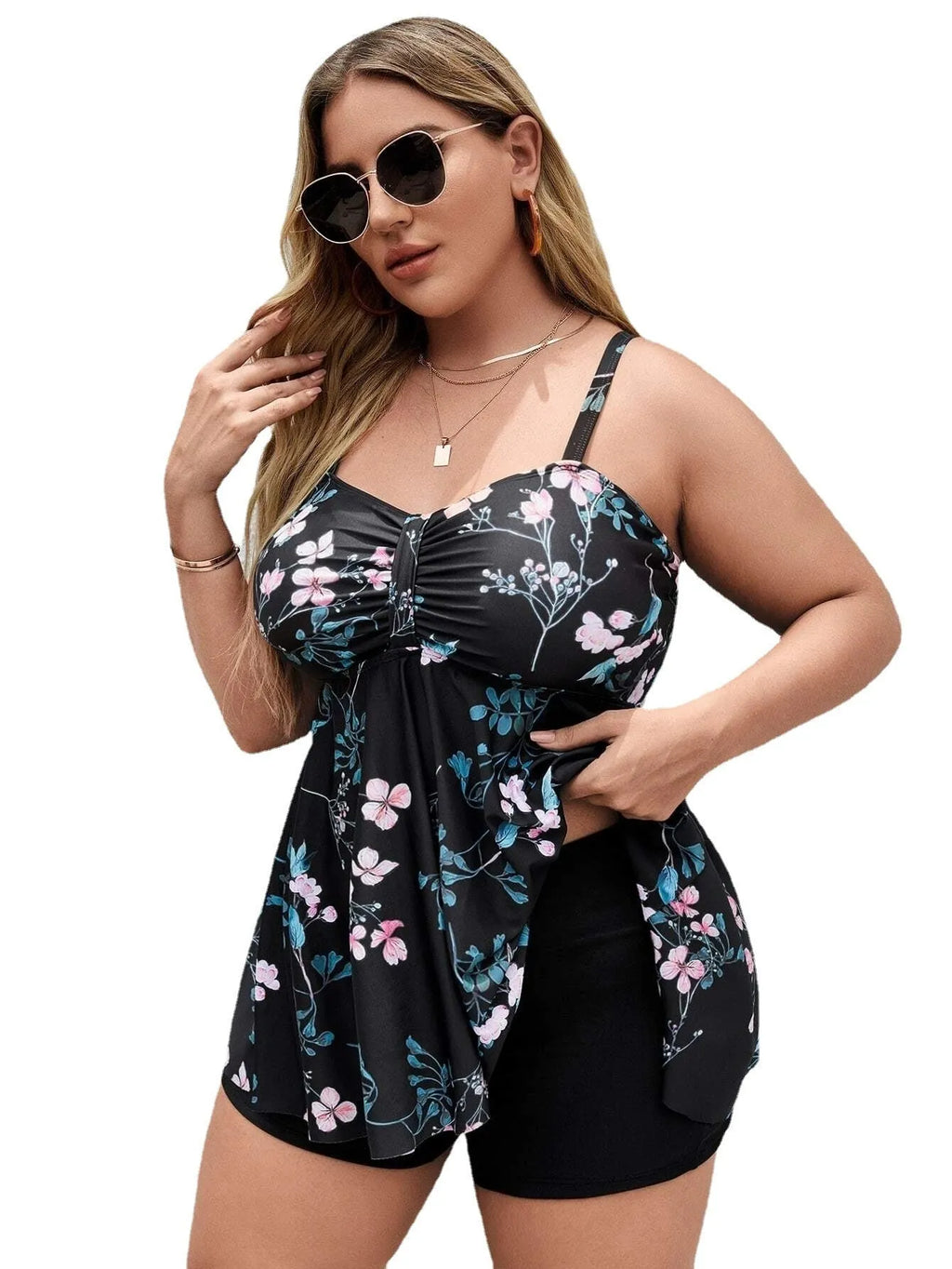 Women's one-piece swimsuit with a split colour floral pattern, shown on a model.