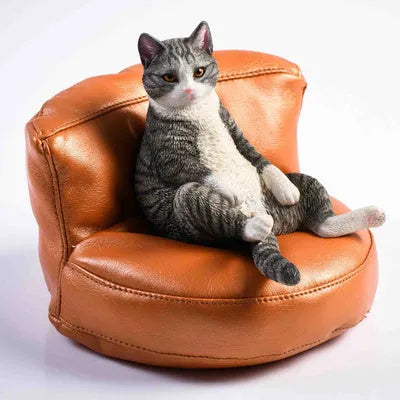 Small lazy cat model resting on a sofa, a resin car dashboard ornament decoration.