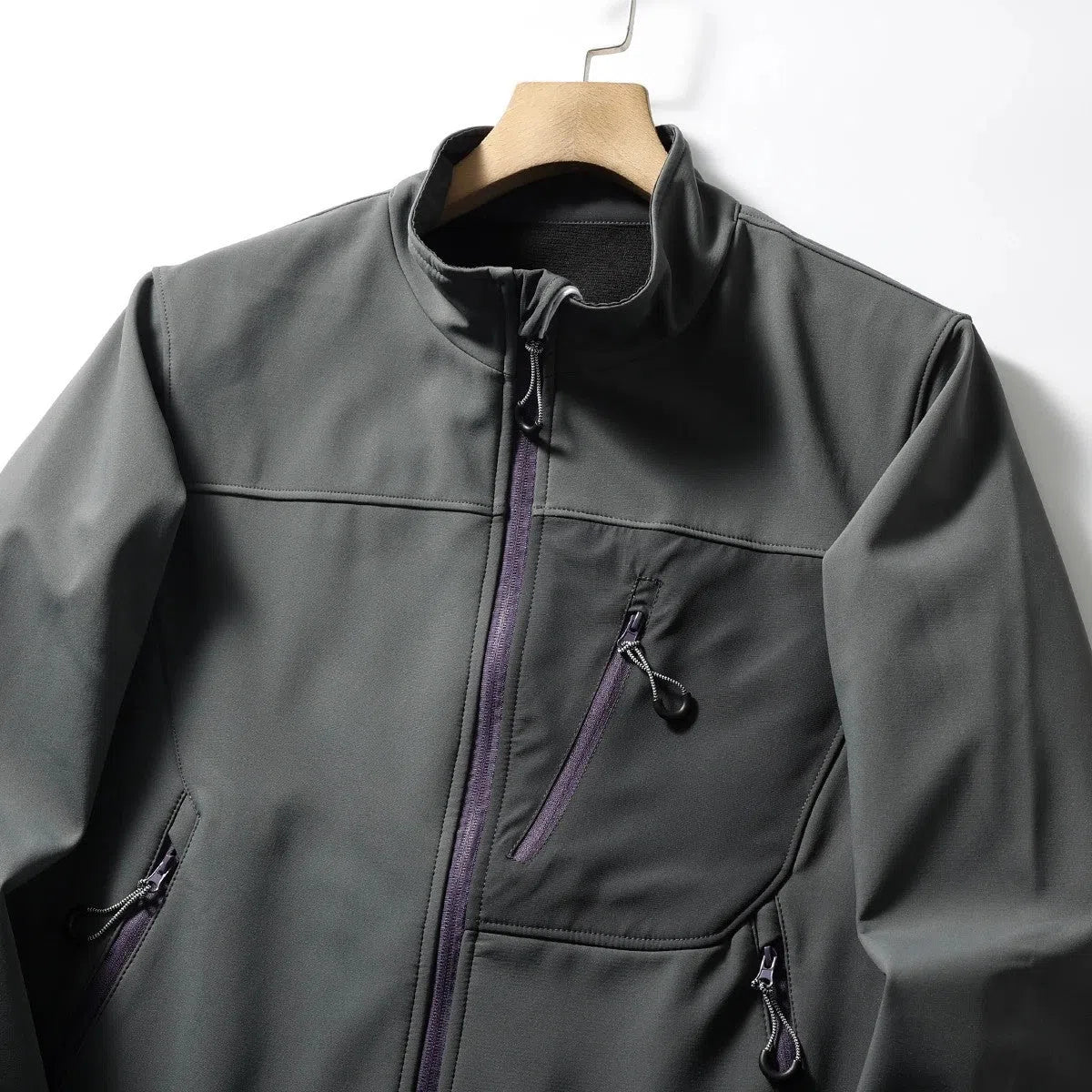 Men's retro patchwork contrast colour stand-up collar coat in Misty White, side view showing zipped pockets