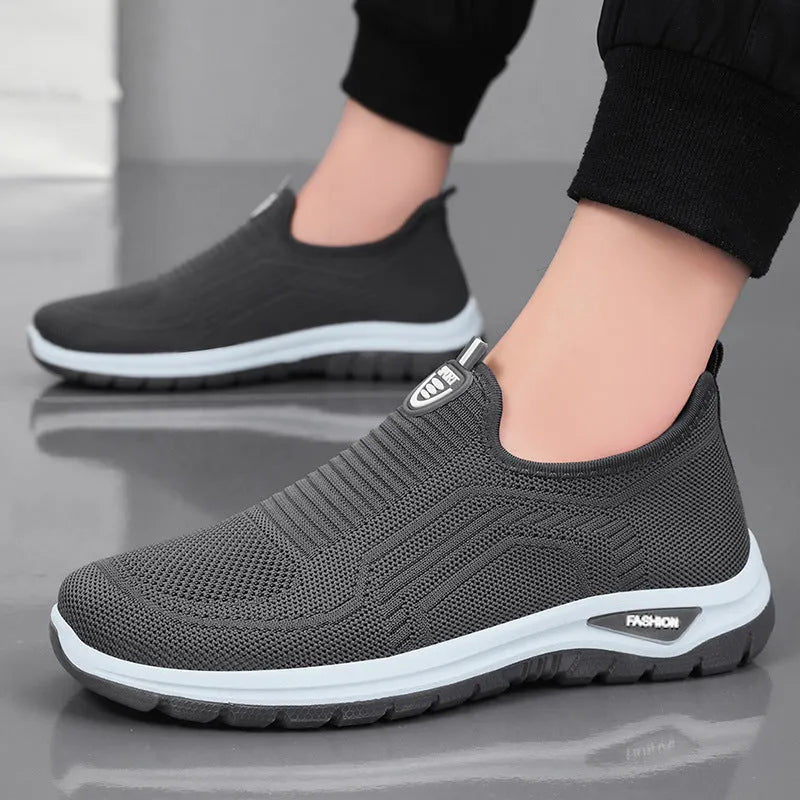 Men's black and grey breathable casual shoes with mesh uppers and PVC soles in a round-toe tennis style.