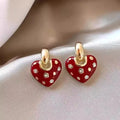 Pair of red heart-shaped ear studs in zinc alloy with electroplated finish