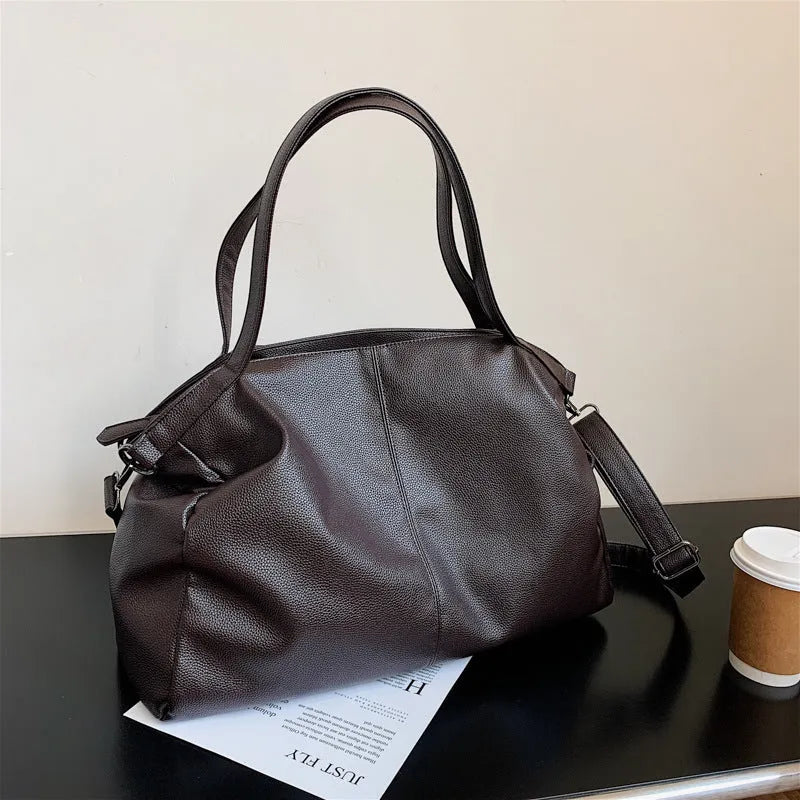 Soft surface messenger shoulder bag in horizontal square shape with zipper opening and internal compartments