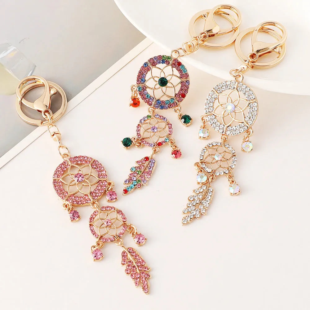 Creative diamond studded flower shaped car keychain dream catcher in pink alloy light luxury style on white background