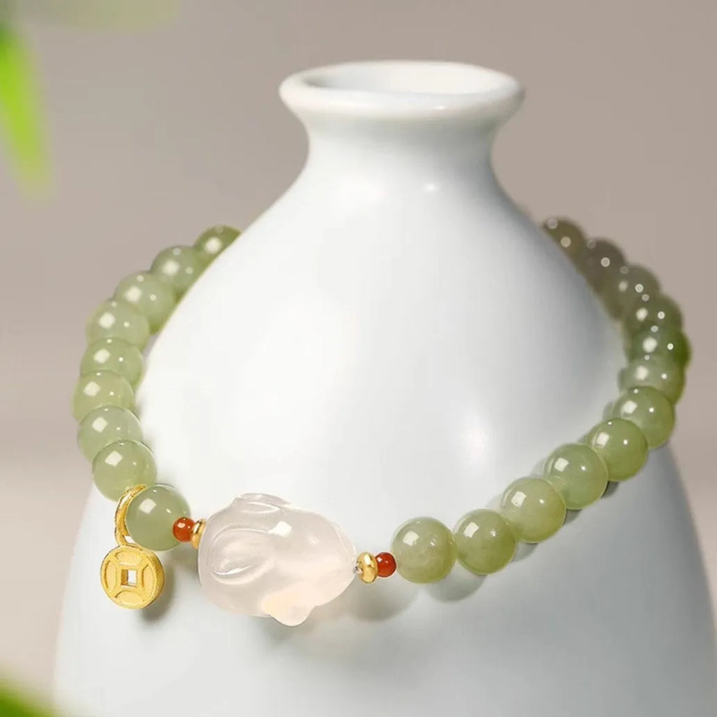 Handmade women's Hetian Jade Rabbit bracelet with glass rabbit charms in a gift box.