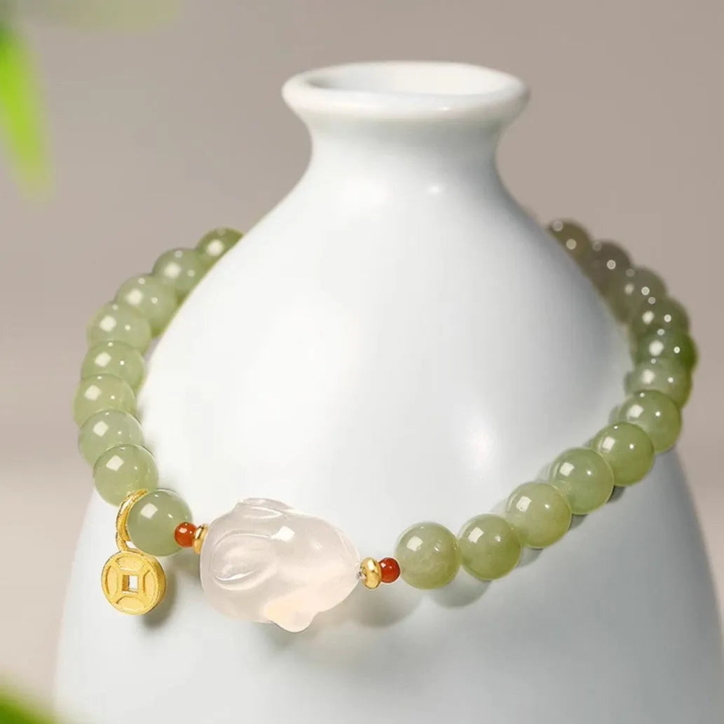 Handmade women's Hetian Jade Rabbit bracelet with glass rabbit charms in a gift box.